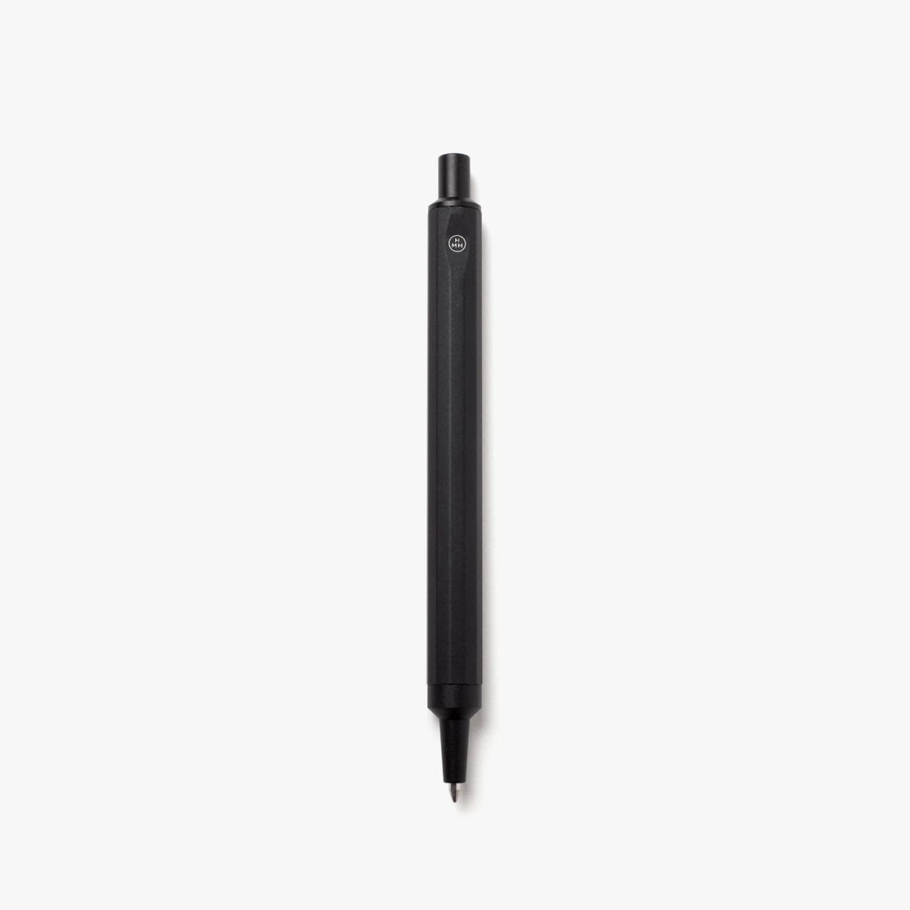 Black machined steel pen with hexagonal grip and small white logo at top.