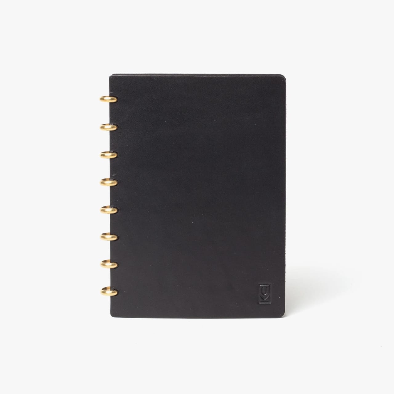 Black leather journal with brass disc binding.