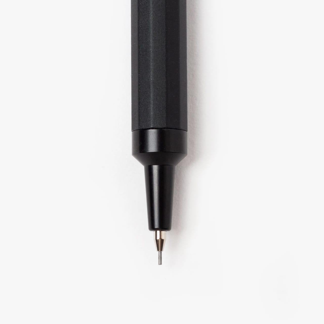 Detail of mechanical pencil tip with machined black steel shaft and chrome lead tip.