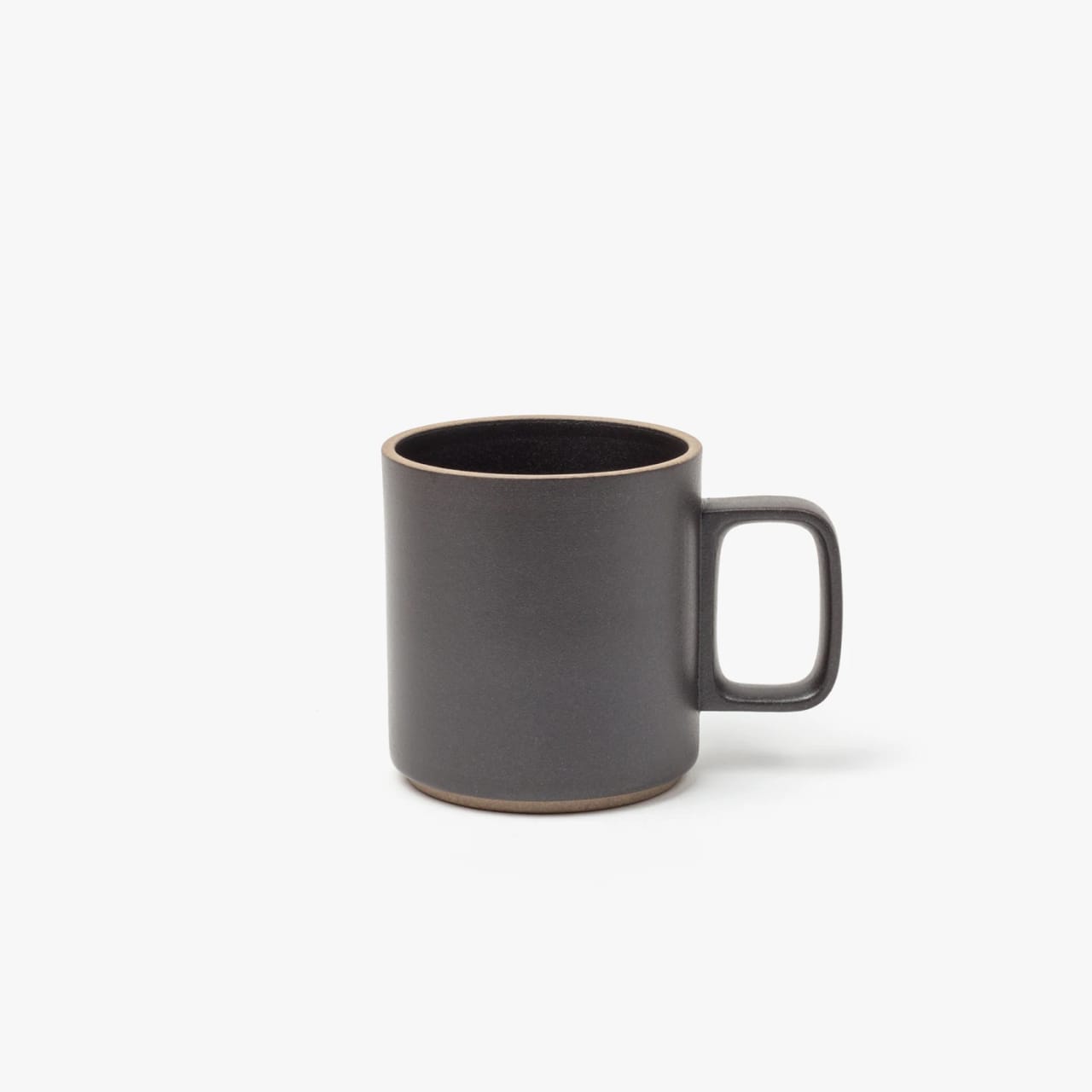 Porcelain clay mug with squared handle, gray textured body, and natural clay rim and bottom.