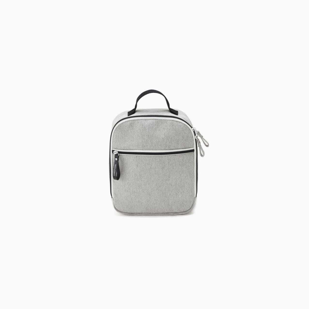 Light grey canvas backpack with black handle, zipper, and edge details.