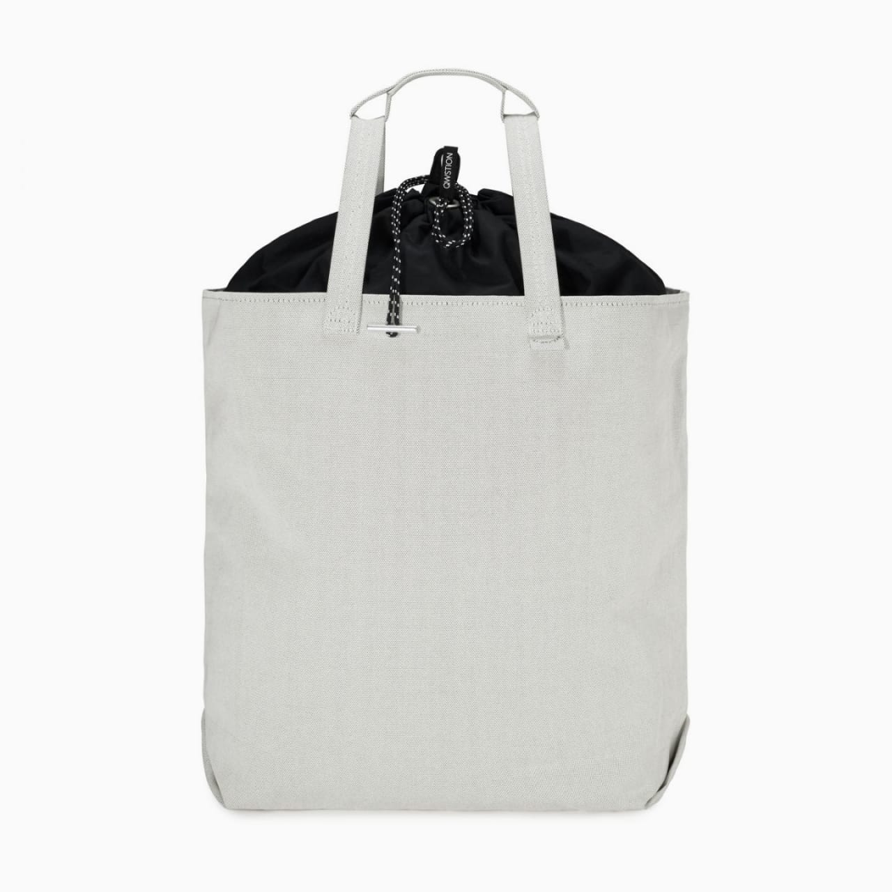 White canvas tote bag with black drawstring liner and white handle.