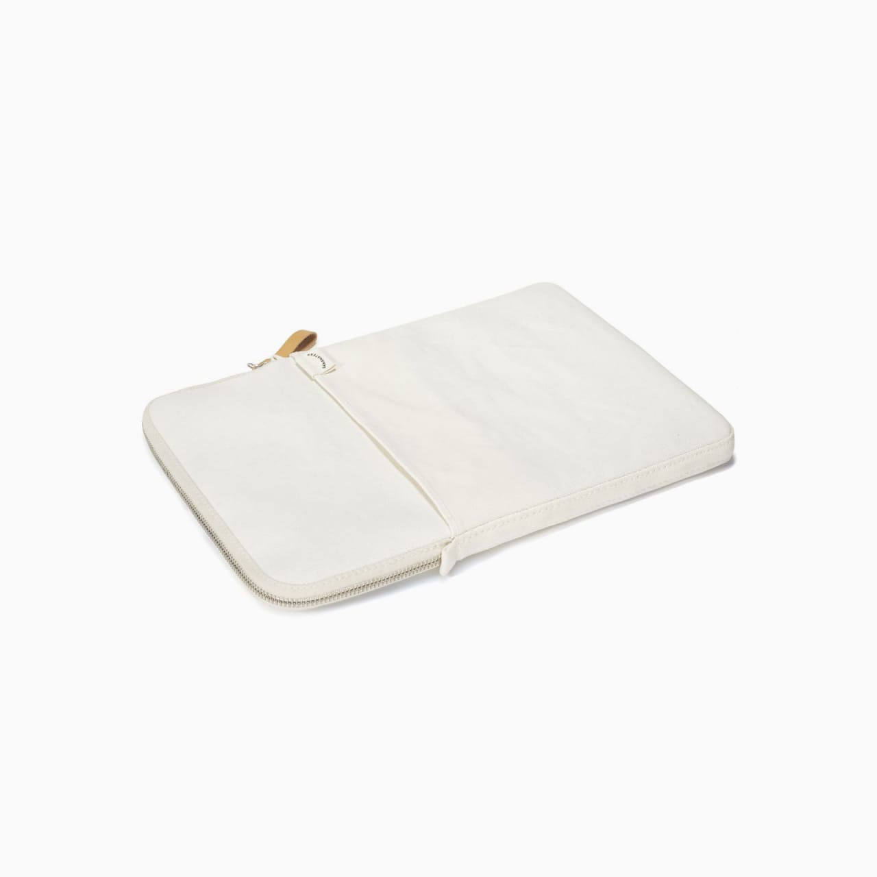 White canvas laptop sleeve with front pocket and tan zipper pull.