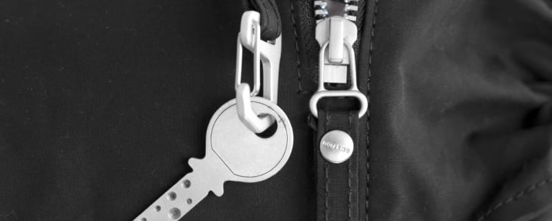 Black canvas body with chrome zipper and key ring.