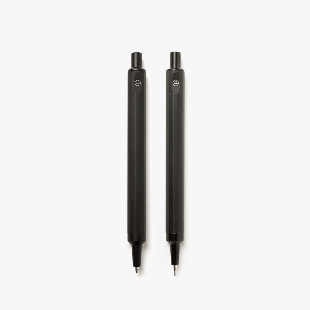 Black machined pen and pencil with hexagonal shaft and small white logo.